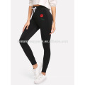 Black Rose Appliques Cordon Skinny Pants OEM / ODM Fabrication En Gros Mode Femmes Vêtements (TA7021L)